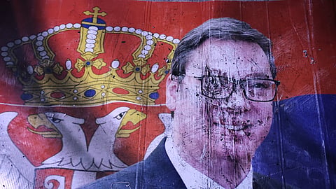 A defaced poster of Aleksandar Vucic, leader of the right-wing Serbian Progressive Party (SNS), lies on the pavement outside the National Assembly after he conceded defeat in the parliamentary election in Belgrade, Serbia, Sunday, Oct. 25, 2026.