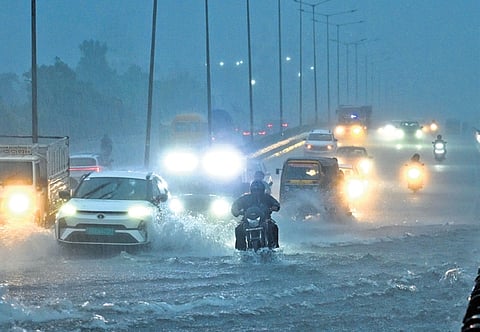 Commuters drive through a flooded NH-16 near CRP Square as heavy rain lashes the city under the impact of cyclonic storm Arnab, in Bhubaneswar