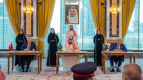 From left, Turkish President Recep Tayyip Erdogan, Saudi Crown Prince Mohammed bin Salman and Pakistani Prime Minister Shehbaz Sharif sign a trilateral defense agreement in Mecca, Saudi Arabia, Friday, Aug. 7, 2026.