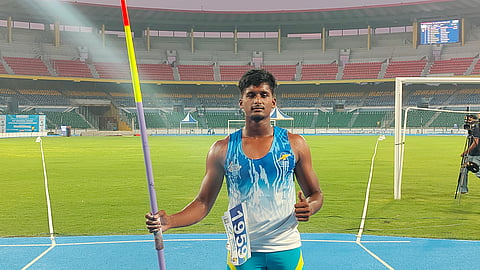 T Dharanidharan poses after winning gold on Tuesday
