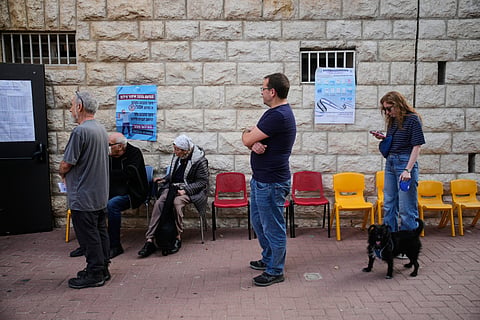 Voters line up before a polling site opens to cast their ballots in Israel's general election, in Jerusalem, Tuesday, Oct. 27, 2026.