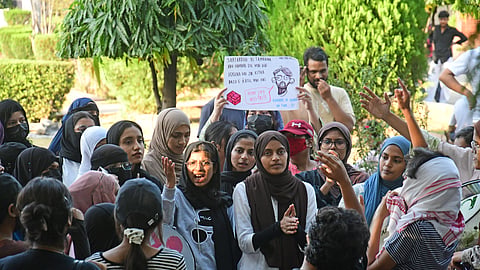 Students of Jamia Millia Islamia stage a protest demanding entry to their campus amid an ongoing strike.