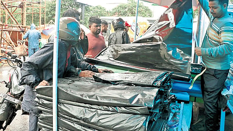 People buy polythene sheets as heavy rain is forecast for capital.