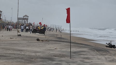 Red warning flags hoisted along the shoreline to restrict visitors from entering the sea as high tidal waves and rough weather prevail under the impact of Cyclone 'Arnab', at Puri beach, in Odisha, Wednesday, Oct. 28, 2026.