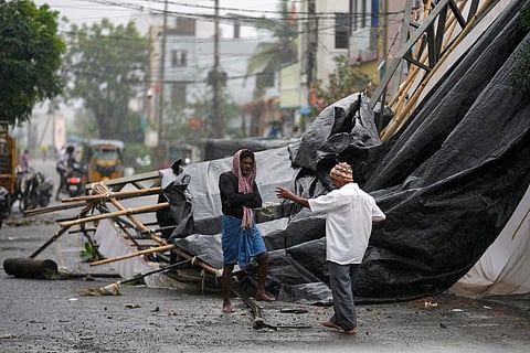 A man walks past the destruction caused at Kakinada, India, after Cyclone Arnab crossed the Andhra Pradesh coast in the early hours of Wednesday, Oct. 28, 2026.
