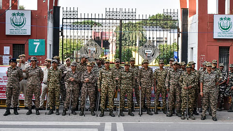 Security personnel stand guard outside Jamia Millia Islamia ahead of the expected visit of Leader of the Opposition in the Lok Sabha Rahul Gandhi to meet protesting students, in New Delhi, Wednesday, Oct. 28, 2026.
