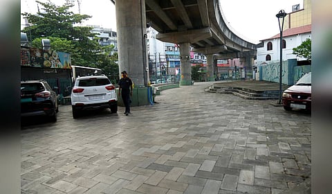 The public activity space owned by KMRL near Jos Junction that has been turned into a private parking facility for a clothing store.