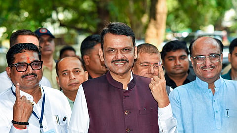 In this photo from Oct. 23, 2026, Maharashtra Chief Minister Devendra Fadnavis shows his inked finger outside the polling booth after casting his vote for the Legislative Council elections, in Nagpur .