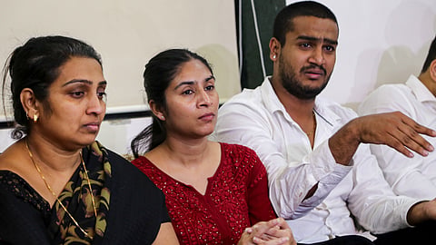 Family members of slain Shiv Sena (UBT) Manpada division chief Pradeep Purnekar address a press conference, in Thane, Maharashtra, Wednesday, Oct. 28, 2026.