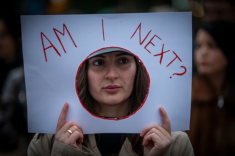 A woman holds a sign “Am I Next” as thousands of people gather in Kosovo’s capital to protest the killing of a Kosovo-American woman, Arlinda Zekaj, whose death sparked public outrage and renewed calls for accountability over violence against women in capital Pristina, Kosovo, on Wednesday, Oct.28, 2026.