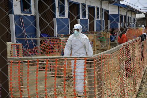 A healthcare worker walks inside a treatment center for Ebola patients in Beni, North Kivu province, eastern Congo, Tuesday, Oct. 27, 2026.