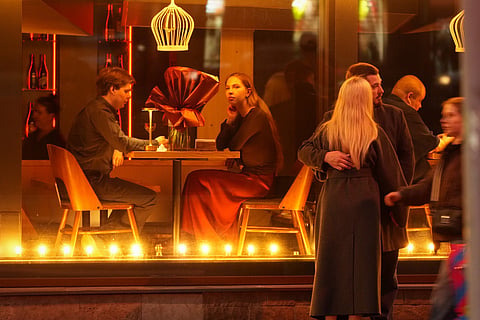 FILE- People sit in a restaurant in St. Petersburg, Russia, Sunday, Oct. 4, 2026.