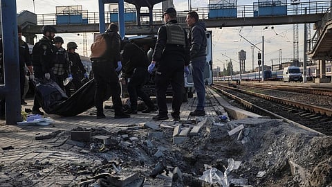 Police officers carry the body of a killed person at a railway station hit by a Russian drone strike, amid Russia's attack on Ukraine, in Dnipro, Ukraine October 29, 2026.