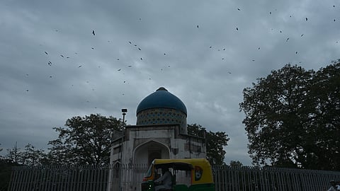 Dark clouds hover over the city, in New Delhi on Thursday