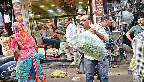 नाशिक : अतिक्रमण निर्मूलन विभागाकडून कारवाई होत असल्याने भाजीपाला सावरताना किरकोळ विक्रेते. (छाया: हेमंत घोरपडे)