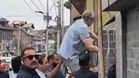 Omar Abdullah climbs wall