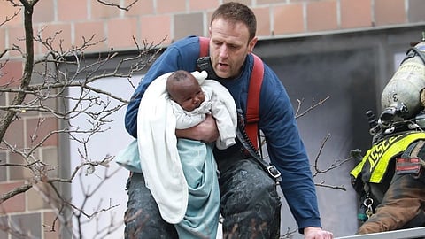 Fire fighter Matt Zimpfer rescuing a baby from deadly bronx fire