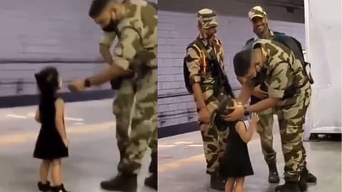 Little girl gets blessings of Soldier