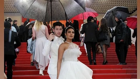 Nick Holds Umbrella For Priyanka