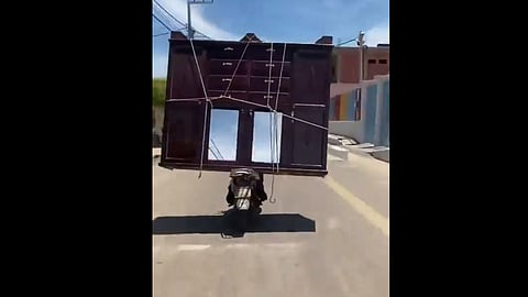 driving scooter with heavy weighted Almirah