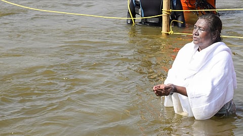Droupadi Murmu prays after taking a holy dip at the Sangam during Maha Kumbh Mela 2025