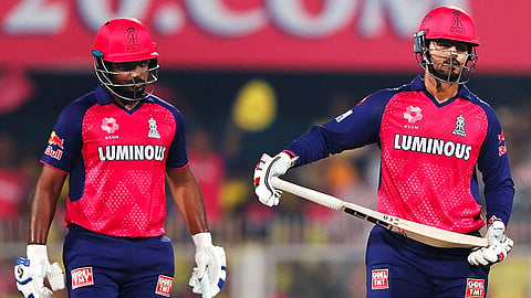 Nitish Rana celebrates his half-century. Sanju is nearby
