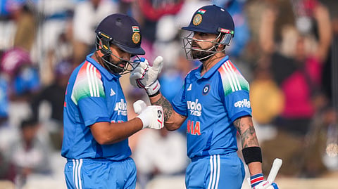India's Virat Kohli, right, and Rohit Sharma greet each other between the wickets during the first ODI cricket match