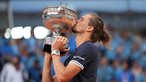 Alexander Zverev of Germany kisses the trophy after winning the men's final match against Flavio Cobolli of Italy at the French Open tennis