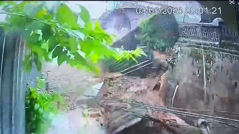 Wall and building collapse onto road in Kannur city