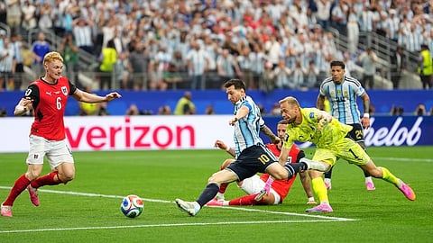 Argentina's Lionel Messi, center, scores his side's second goal during the World Cup Group J soccer match between Argentina and Austria