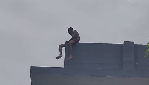 Youth climbs on top of water tank and threatens to commit suicide