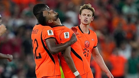 Netherlands' Cody Gakpo (11) celebrates with teammates after scoring the opening goal during the World Cup round of 32 soccer match between the Netherlands and Morocco