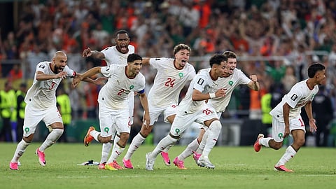 The Moroccan team starts to celebrate after winning on penalty kicks the World Cup round of 32 soccer match between the Netherlands and Morocco