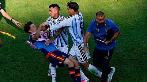 Spain's Gavi, left, falls as he scuffles with Argentina's Leandro Paredes (5) and Thiago Almada during the World Cup final soccer match between Spain and Argentina