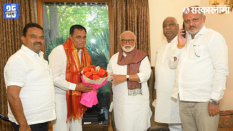 Newly elected Lasalgaon Market Committee chairman D.K. Jagtap receiving blessings from Chhagan Bhujbal