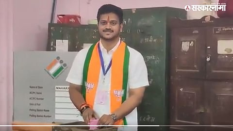 NCP (Sharadchandra Pawar) leader Jitendra Awhad has raised questions over a viral video allegedly showing BJP candidate Kaustubh Gawade wearing a scarf bearing the lotus symbol while voting.