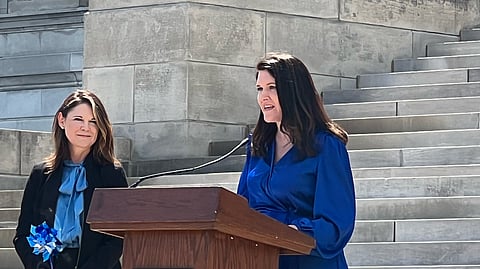 Secretary Kristi Putnam of the Arkansas Department of Human Services listens as Karen Phillips, Associate Director Community Development at Restore Hope speaks at an event for Child Abuse Prevention Month in 2023.