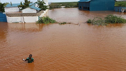 FLOODED. A man swims from a submerged church compound, after the River Tana broke its banks following heavy rains at Mororo, border of Tana River and Garissa counties, North Eastern Kenya, Sunday, April. 28, 2024. /