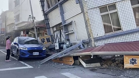 TAIWAN. In this image taken from a video footage run by TVBS, a woman stands near a partially collapsed building in Hualien, eastern Taiwan on Wednesday, April 3, 2024.