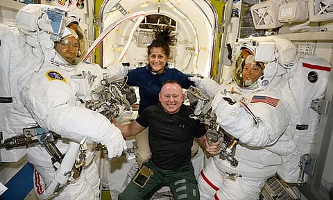 In this photo provided by NASA, Boeing Crew Flight Test astronauts Suni Williams and Butch Wilmore, center, pose with Expedition 71 Flight Engineers Mike Barratt, left, and Tracy Dyson, both NASA astronauts, in their spacesuits aboard the International Space Station's Quest airlock on June 24, 2024.