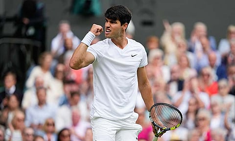 Carlos Alcaraz of Spain reacts during his semifinal match against Daniil Medvedev of Russia at the Wimbledon tennis championships in London, Friday, July 12, 2024.