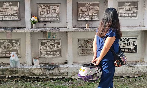 A woman searches for her loved one’s tomb at Wireless Cemetery along Fr. Selga Street in Davao City on Tuesday, October 29. Crowds are anticipated to gather beginning October 30 to observe All Saints' Day and All Souls' Day.