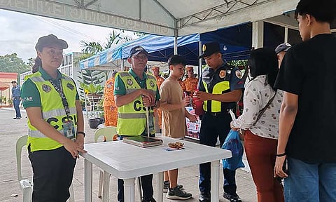 Security personnel conducted inspections on visitors entering the Wireless Cemetery along Fr. Selga Street in Davao City, ensuring safety and security measures for All Saints' Day and All Souls' Day observances.