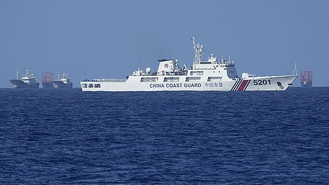 MANILA. In this file photo, Chinese coast guard vessel stays beside suspected Chinese militia ships near Thitu island, locally called Pag-asa Island on Wednesday, November 6, 2024, ahead of a Philippine military multi-service joint exercise at the disputed South China Sea.