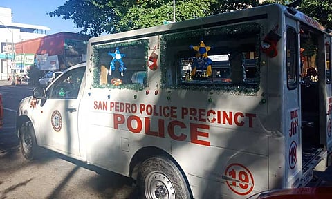 In this file photo, a mobile police car parked in front of the San Pedro police station was spotted to have Christmas decorations all over but with the tarpaulin of wanted individuals too.