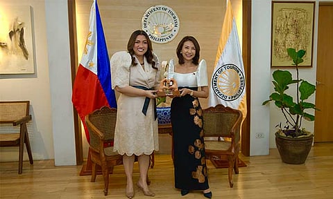 Cleofe Albiso, Managing Director of Megaworld Hotels & Resorts, received a “Love the Philippines” token from DOT Secretary Christina Frasco.