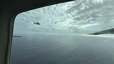 A Chinese military helicopter flies close to a Philippine Bureau of Fisheries and Aquatic (BFAR) aircraft