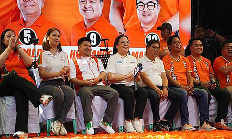 Fourth from left: Trabaho Partylist first nominee Atty. Johanne Bautista, seated between Mayor Along Malapitan and Cong. Oca Malapitan, is all smiles during the Team Aksyon and Malasakit’s Grand Rally at Distrito Uno, Caloocan City.