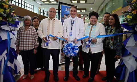 MILESTONE CELEBRATION. Officials open the Department of Migrant Workers' (DMW) 30-Year Milestone of Labor Migration Governance Photo Exhibit at the DMW office in Mandaluyong City on Monday (June 2, 2025). Cutting the ribbon are Commission on Filipino Overseas Secretary Dante “Klink” Ang II, Department of Migrant Workers (DMW) Undersecretary Bernard Olalia, and Overseas Workers Welfare Administration (OWWA) Administrator Patricia Yvonne Caunan (foreground, left to right). (Photo courtesy of DMW)