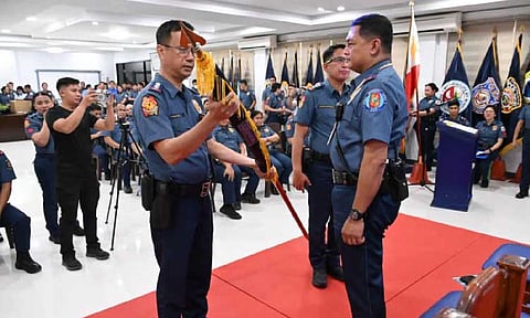 Colonel Eugene Marcelo, incoming Pampanga police director, accepts the unit flag from Brigadier General Ponce Rogelio Peñones, newly-installed Central Luzon police director. Also in photo is outgoing Pampanga police director, Colonel Jay Dimaandal. Photo courtesy of Pampanga PPO